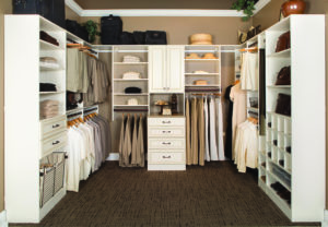 Walk-in closet with white cabinets and shelving 