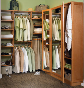 Walk-in closet with shelving for shoes and racks for shirts